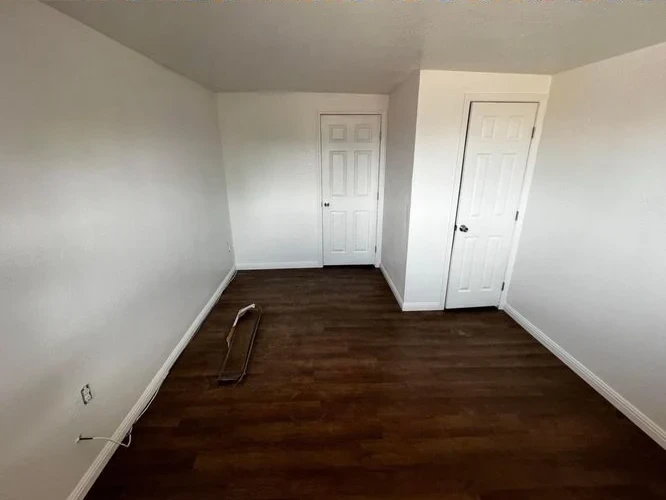 After: finished walls and wood-look flooring in the same room