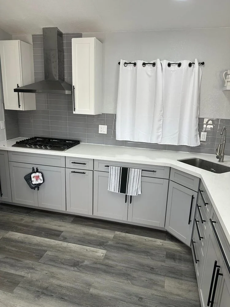 Sunnyside Remodels kitchen with gray cabinetry, white countertops and a tiled backsplash