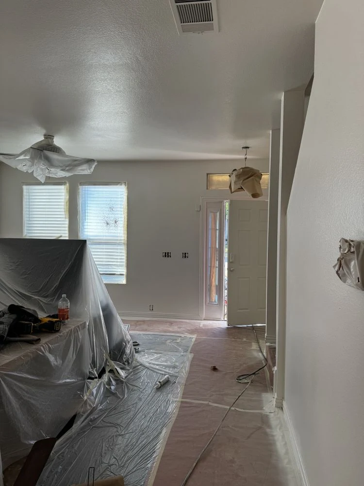 Living room and entry masked and protected during interior painting