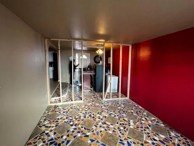 Before: room with open framing during renovation
