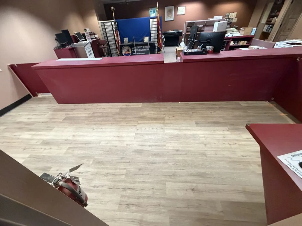 Light wood-look plank flooring installed behind an office service counter