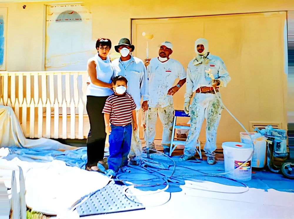 Painting crew with homeowners during an exterior painting job